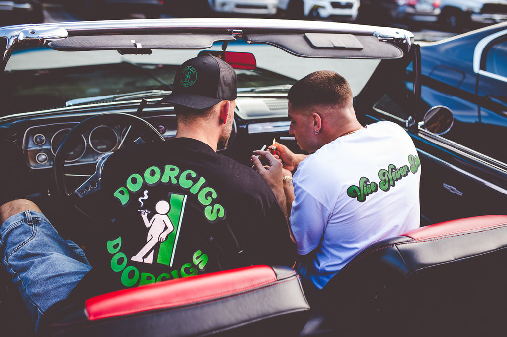 men’s premium streetwear clothing and smoke break tees in a classic car with black and red interior