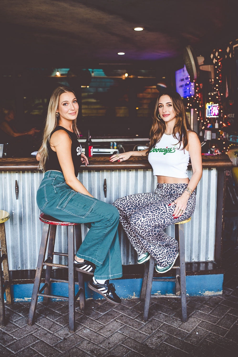 Models wearing Doorcigs luxury streetwear — small-batch tees, crop tanks, and snapbacks from the independent brand.