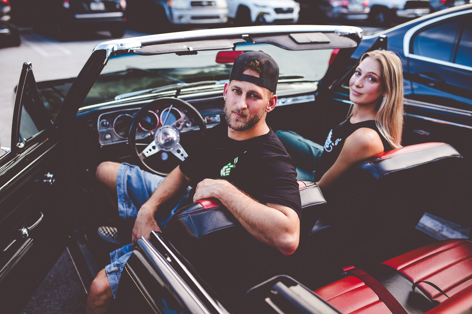 Lifestyle photo of models wearing american independent streetwear brand Doorcigs retro graphic tees and crop tanks in classic convertible in Delray Beach Florida